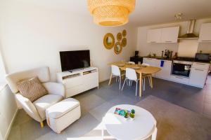 a kitchen and a living room with a table and chairs at Residence Royal Sélys, City-Center - Bike Parking and Outdoor in Liège