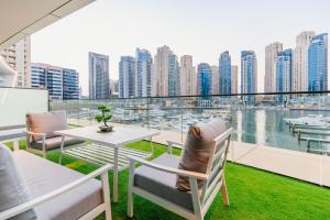 a balcony with a table and chairs and a view of a city at Vida Dubai Marina & Yacht Club , Hotel and Residences , Luxurious 2BR in Dubai