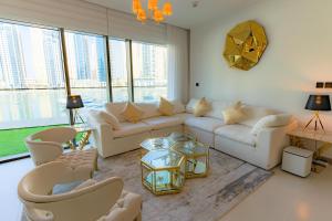 a living room with white furniture and large windows at Vida Dubai Marina & Yacht Club , Hotel and Residences , Luxurious 2BR in Dubai