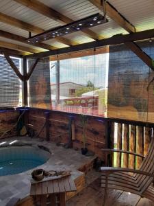 a patio with a swimming pool and a large window at Kami lodge f3 jacuzzi in Rivière-Salée