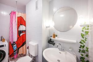 a white bathroom with a sink and a mirror at Pop Art Loft über den Dächern von Koblenz in Koblenz +20 photos