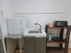 a kitchen with a sink and a microwave at BlueBird Guesthouse - Foreign Only in Seoul