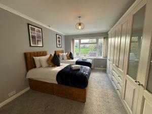 a bedroom with a large bed and a window at Quebec House - Free Parking and Wifi, 'Comfortable Spacious House Near to Town Centre in Swindon