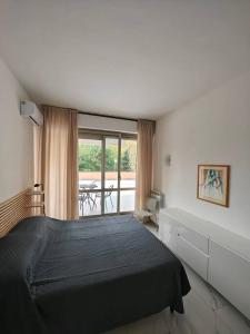 a bedroom with a black bed and a balcony at Appartamento Aurelio - Vaticano in Rome