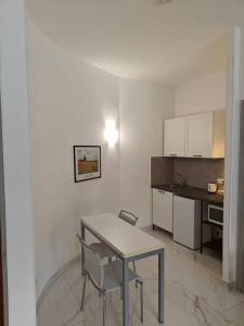 a kitchen with a table and a table and a table and chairs at Appartamento Aurelio - Vaticano in Rome