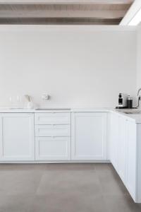 eine weiße Küche mit weißen Schränken und Geräten in der Unterkunft Bottego24 Suite, Apartment & Terrace in Nardò