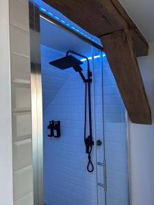 a shower with a blue light in a bathroom at Zur Scheune in Bad Wildungen