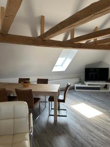 a dining room with a wooden table and chairs at Zur Scheune in Bad Wildungen