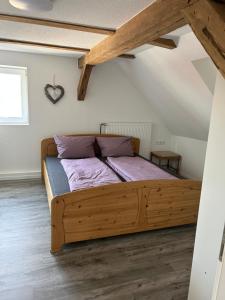 a bedroom with a wooden bed in a attic at Zur Scheune in Bad Wildungen