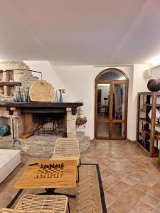 a living room with a stone fireplace and a table at laCelletta Country House in Urbino