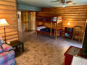 a bedroom with bunk beds in a log cabin at Buffalo River Lodge (Yellville)- Lower Level in Saint Joe