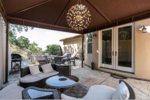 an outdoor patio with a chandelier and a table and chairs at Hills of Studio City, your serene home away from Home in Studio City