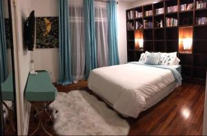 a bedroom with a bed and a television and a table at Hills of Studio City, your serene home away from Home in Studio City