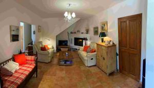 a living room with two couches and a fireplace at Maison de vacances à louer dans le Gard Provençal, semaine de 7 jours minimum, samedi au samedi, 10 personnes, Le Mas du Colombier in Saint-Michel-dʼEuzet