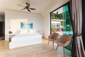 a bedroom with a bed and a sliding glass door at The Dreaming View Villa in Haad Yao +73 photos