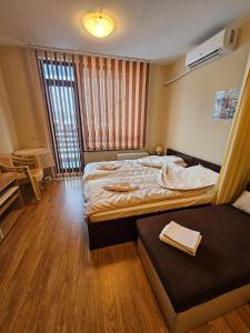 a hotel room with two beds and a window at Aspen Valley B304 in Razlog