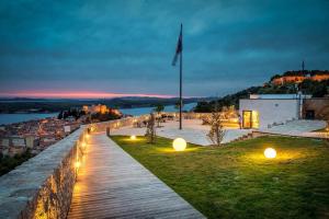 a wooden walkway with lights in a city at night at Urban Lights Hideaway in Šibenik