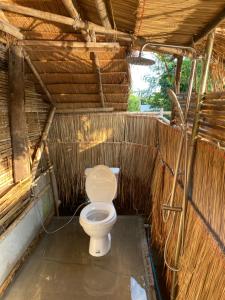 a bathroom with a toilet in a shack at Royal mountain lake view in Ratchaburi