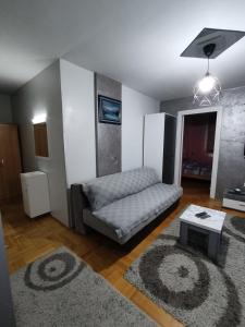 uma sala de estar com um sofá e uma mesa em Apartman “MEGI” em Sokobanja