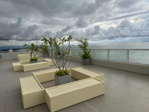 a balcony with couches and a view of the ocean at Joansa Luxury Beachfront Apartment in Uswetakeiyawa