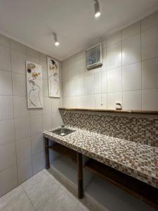 a kitchen with a bench and a sink in it at Tiga Naga Villa in Denpasar