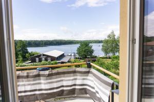a view of the water from the balcony of a house at Apartmenthaus am Grienericksee in Rheinsberg