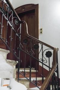 a staircase with a wrought iron railing and a wooden door at Residenza Duomo3 - Apartments in Verona