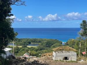 a view of the ocean from a house at Bas de villa couleuvre in Deshaies