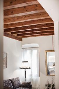 a living room with wooden ceilings and a couch at Residenza Duomo3 - Apartments in Verona