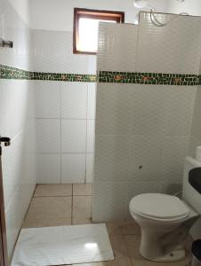 a bathroom with a toilet and a shower at Pousada Luz do Sol in Sao Jorge