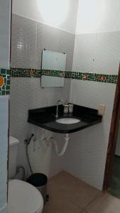 a bathroom with a sink and a toilet at Pousada Luz do Sol in Sao Jorge