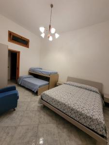 a bedroom with two beds and a ceiling at I ciclamini in Monopoli