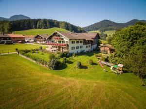 an aerial view of a large house on a green field at Schneider-Hof in Ruhpolding