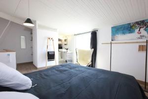 - une chambre avec un lit bleu et une chaise dans l'établissement Hypercentre terrasse clim, à Aix-en-Provence