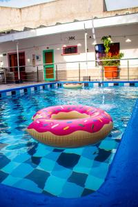 - une piscine avec un flotteur rose dans l'eau dans l'établissement SGH hotel Mathilu Rodadero, à Santa Marta
