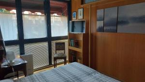 a bedroom with a bed and a desk and a tv at Il Girasole in Milan +11 photos
