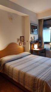 - une chambre avec un grand lit et un bureau dans l'établissement Il Girasole, à Milan