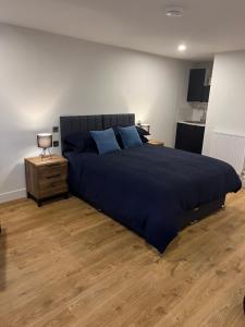 a bedroom with a large bed with blue pillows at Green haven in Winford