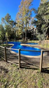 a swimming pool in a park with a fence at Nuevo y cómodo Departamento en Pucón in Pucón