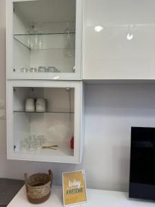 a white cabinet with a sign that reads fragile awesome at 4 Beds Apartment close PARIS center in Vanves