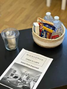 a basket of food and a magazine on a table at 4 Beds Apartment close PARIS center in Vanves