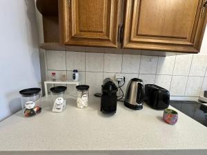 a kitchen counter with various appliances on a counter top at 4 Beds Apartment close PARIS center in Vanves