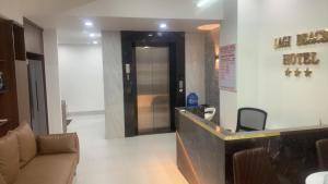 a lobby with a waiting room with a door and chairs at Lagi Beach Hotel in Lagi