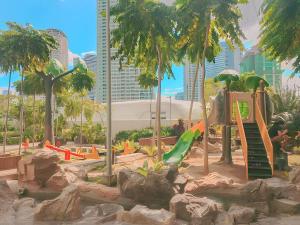 a playground with a slide in a park at Aveline Suites Elite Rockwell view ACQUA Private Residences near Rockwell Makati in Manila