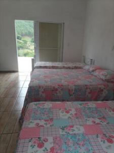 Кровать или кровати в номере Recanto do Sol