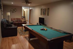 a living room with a pool table in it at Barn house in Saint Joe