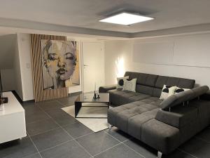 a living room with a couch and a table at Stilvolles Designappartment mit Terasse & Garten im idylischem Bindlach in Bindlach