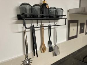 a shelf with cooking utensils on a wall at Stilvolles Designappartment mit Terasse & Garten im idylischem Bindlach in Bindlach
