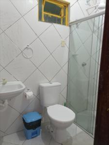 a bathroom with a toilet and a glass shower at Casa Eco Via Norte - MCZ in Maceió