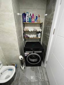 a small bathroom with a toilet and a sink at Luxury apartment by versace in Istanbul